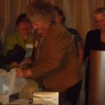 Pat Smith unwraps her award with (L) Children's Editor, Sandy Berenbaum (CT),   cheering her on.