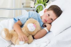 Little boy with teddy bear in hospital