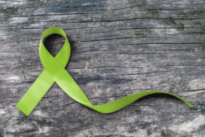 Lime Green ribbon for Lymphoma Cancer and mental health awareness raising support patient living with illness